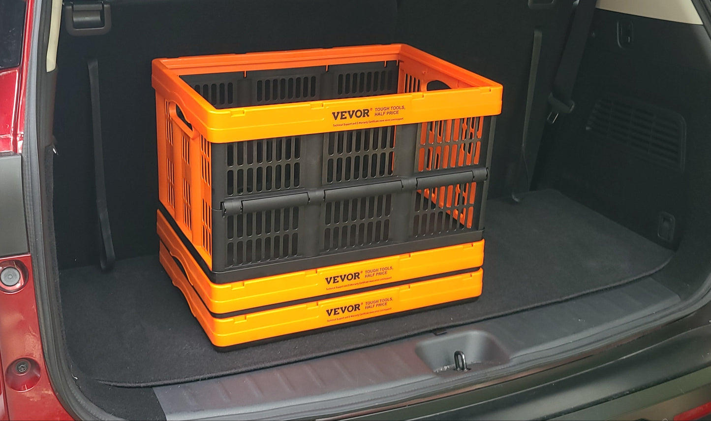 Two orange and black collapsible storage crates stacked inside the open trunk of a red vehicle.
