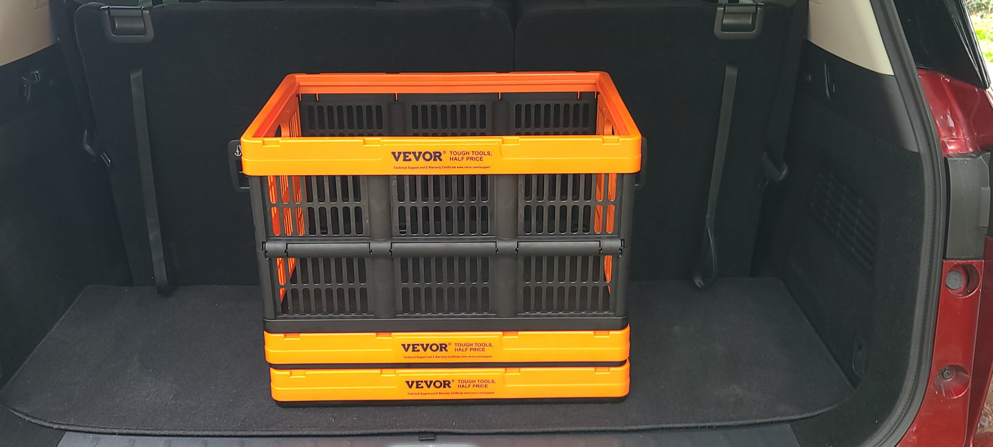 Collapsible plastic storage crate in orange and black, stacked inside the trunk of a vehicle.