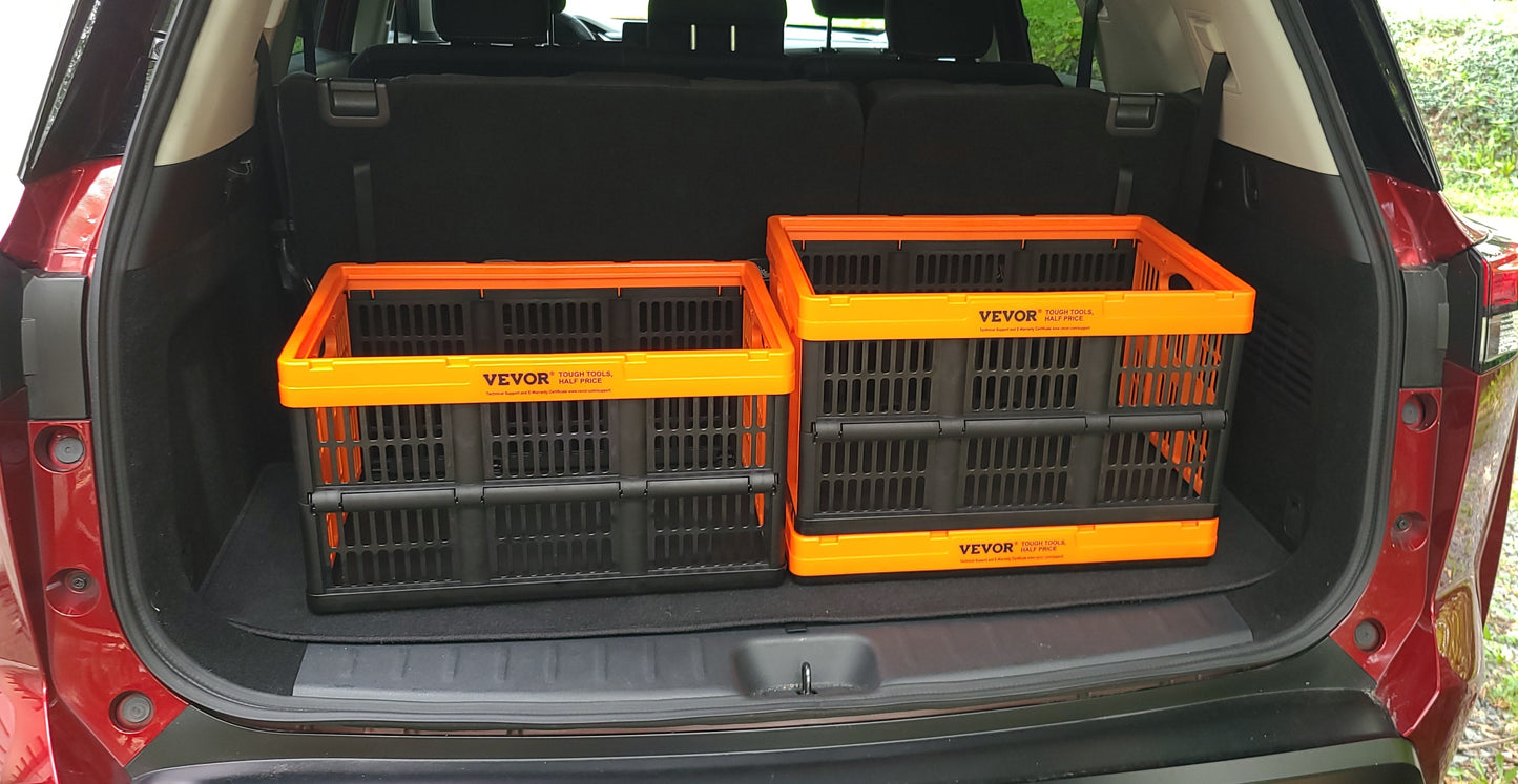 Two orange and black collapsible storage crates set up open in the trunk of an SUV.