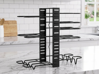 A black metal pot and pan organizer with multiple tiers and a base, shown on a white marble kitchen counter with a white subway tile backsplash in the background.