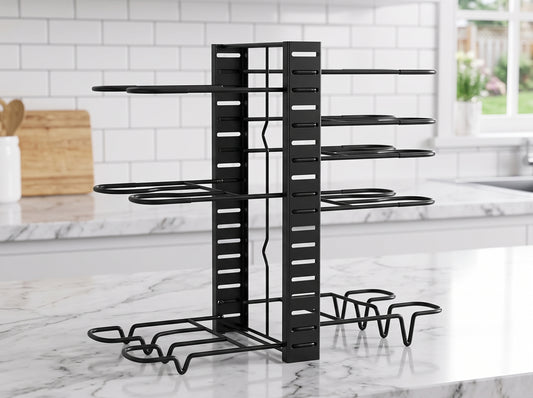 A black metal pot and pan organizer with multiple tiers and a base, shown on a white marble kitchen counter with a white subway tile backsplash in the background.