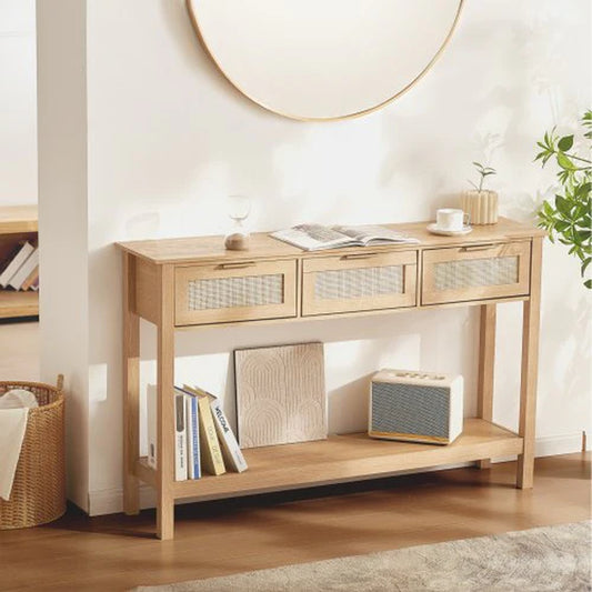 Wooden console table with storage drawers and a shelf in a room setting.
